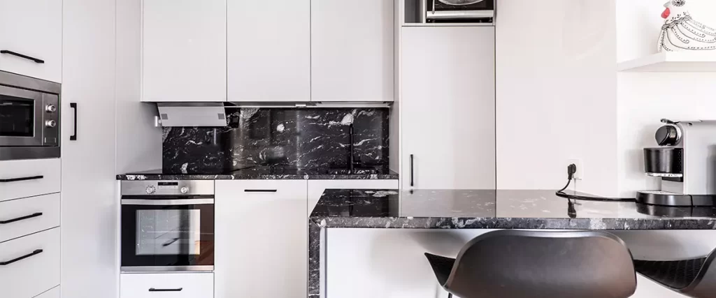 full white kitchen, white kitchen cabinets with black marble countertop