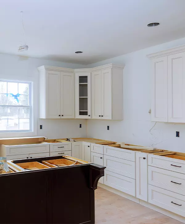 Interior design construction of a kitchen with cabinet maker installing custom cabinets