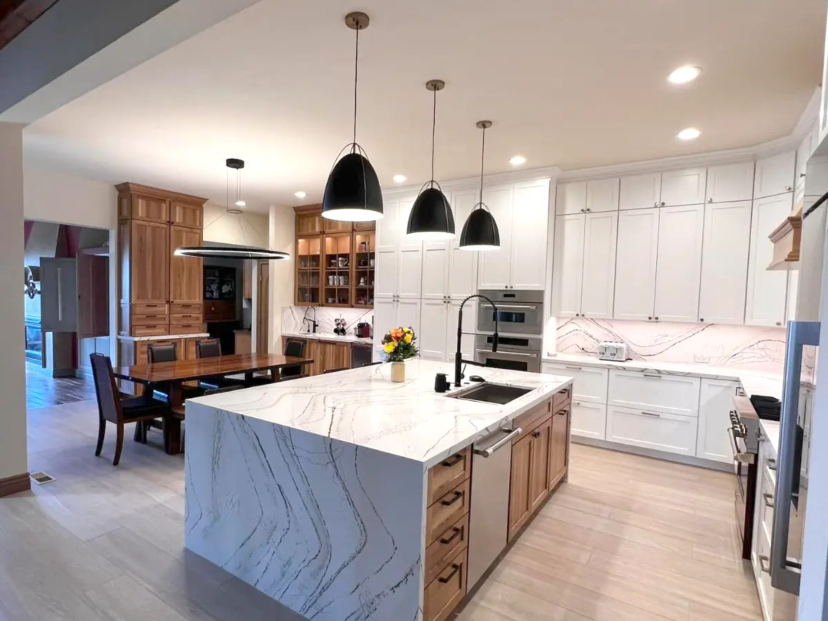 Full kitchen remodel with custom cabinets in white and wood texture with waterfall custom island and open space concept