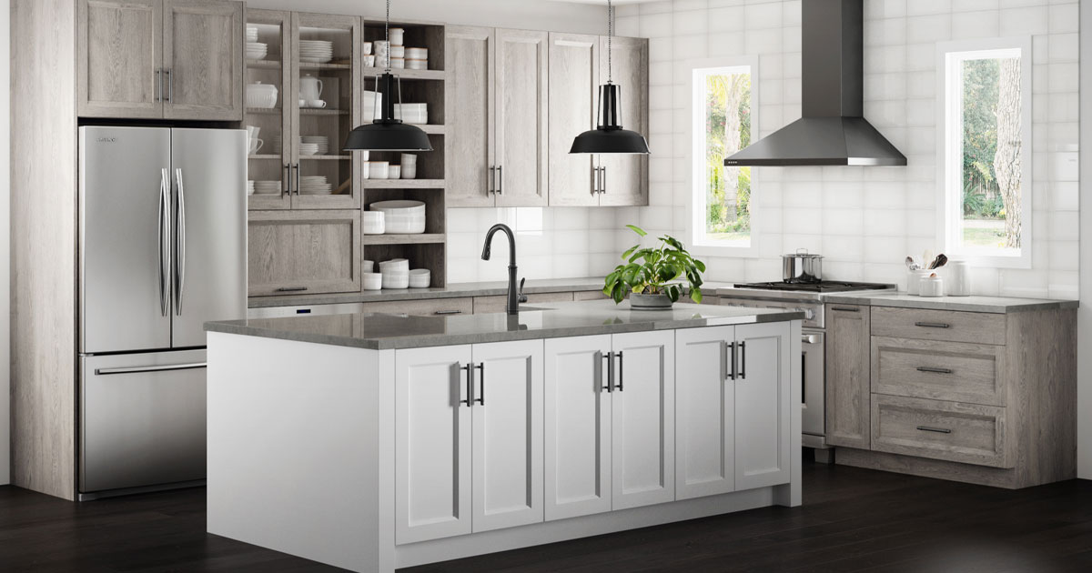 Contemporary kitchen design with light wood cabinets, white island, black fixtures, and stainless steel appliances