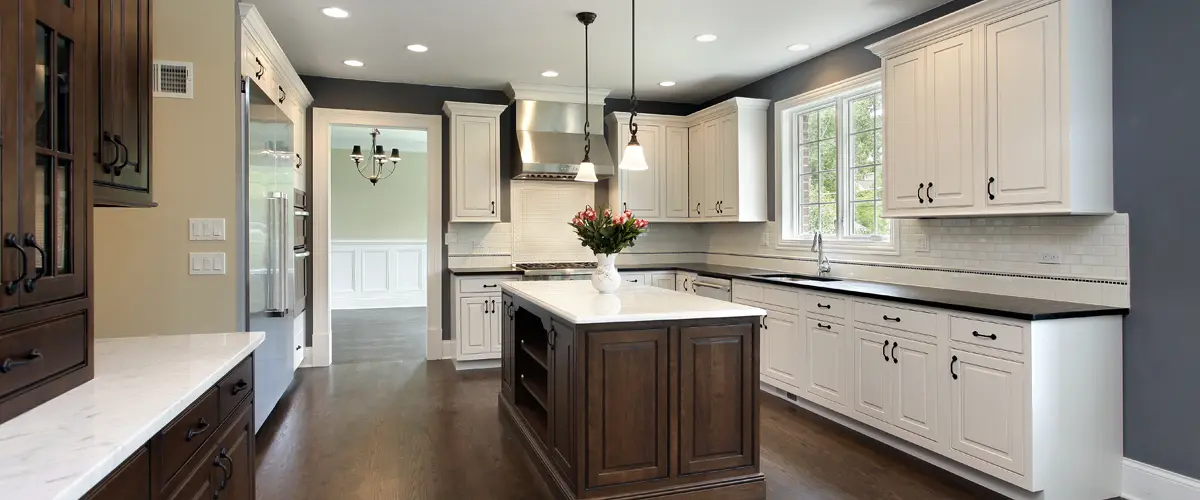 Elegant kitchen with white cabinets and dark island centerpiece